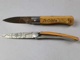 two knives that are sitting next to each other on a table