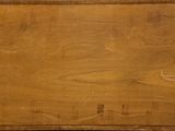 an old wooden box with a handle on top of a table