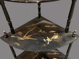 a three tiered shelf with a painting on it