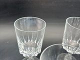 three wine glasses sitting on a table next to each other