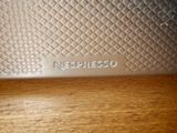 a close up of a silver plate on a wooden table