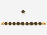 a gold bracelet with black stones