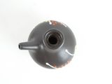 a black tea pot with a flower design on it
