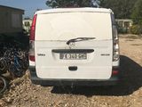 a white van that is parked in the dirt