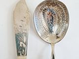 two silver spoons and a silver spoon on a table