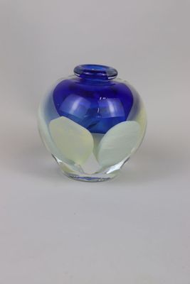 a glass vase with a blue and white design on it