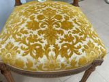 a close up of a chair with a yellow and white upholstered seat