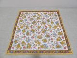 a close up of a table cloth with flowers on it