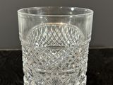 a close up of a clear glass cup on a black surface
