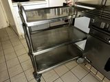 a metal cart that is sitting in the middle of a kitchen