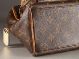 a close up of a louis vuitton bag on a table
