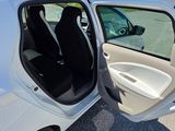 a white car with its door open in a parking lot