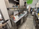 a large kitchen with a lot of stainless steel counter tops