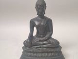 an image of a statue of a buddha sitting on top of a table