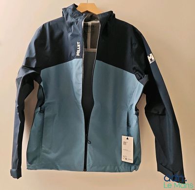 a blue and black jacket hanging on a hanger on a wall