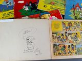 many children ' s books on the table with pictures of them