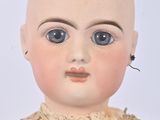 an old doll with a bald head and blue eyes