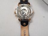 wrist watch with black leather strap and gold face