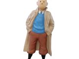 statue d'un homme en trench-coat, debout sur un socle noir