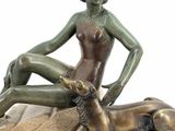 bronze statue of a woman and a dog on a marble base