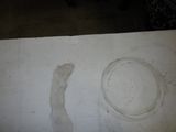 a white table with a bowl and a plate on it