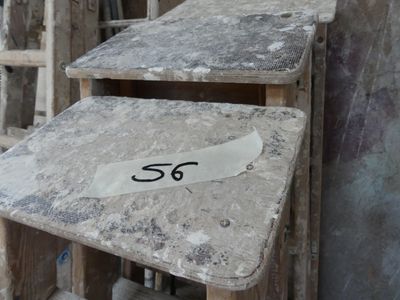 two tables that have numbers on them in front of a building