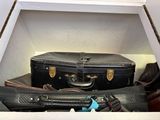several pieces of luggage are stacked on top of each other in a box