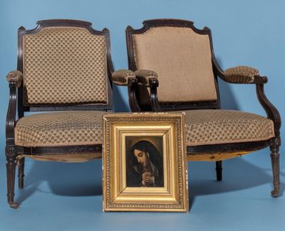 two chairs with a picture of a man sitting on one of them