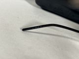 a pair of glasses sitting on a table next to a laptop