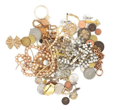 a pile of gold and silver jewelry on a white surface