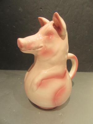 un vase en forme de cochon rose posé sur une table