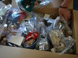 a man that is standing over a box full of toys