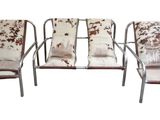 three metal chairs with cow hide covers on them sitting next to each other