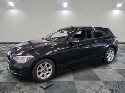 a picture of a black bmw suv parked in a showroom