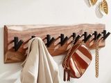 le porte-manteau est fabriqué à partir d'un morceau de bois et comporte des crochets