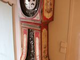 a grandfather clock in the corner of a living room