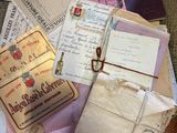 a pile of old letters and envelopes on the floor