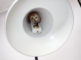 a white lamp that is on a table with a black cord