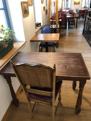 a table and chairs in a room with wood floors