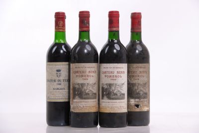 three bottles of red wine sitting on top of a white table