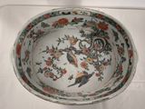 a white bowl with a bird and flowers design on it