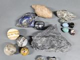 several different types of rocks and stones on a gray surface