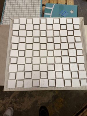 a white keyboard sitting on top of a table next to a pair of shoes