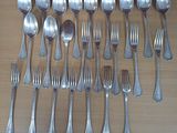 a lot of silver spoons and forks on the table