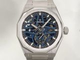 a silver watch with a blue face on a white background