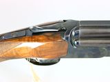 the side view of a shotgun with a wooden handle on a white background