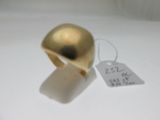 a gold ring with a tag attached to it