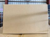 cardboard box sitting on top of a wooden table in a warehouse