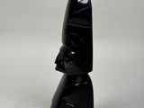 a black sculpture of a person with a hat on it
