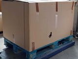 a large cardboard box on a pallet in a warehouse